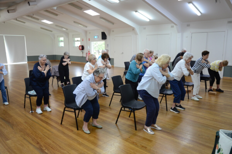 Students practicing fall prevention exercise of sit to stand